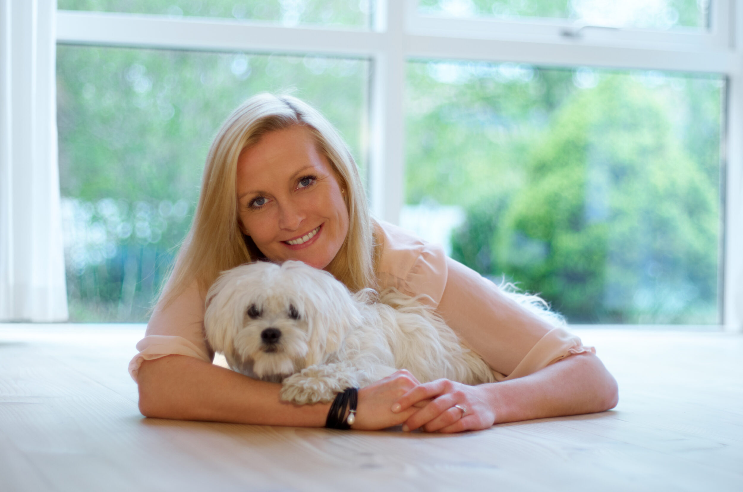 Womans best friend too. A woman bonding with her Maltese poodle.